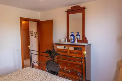 a bedroom with a dresser and a mirror at Villa Azzurra con vista sul mare in San Vito lo Capo