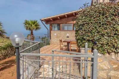 a villa with a staircase leading to a house at Villa Azzurra con vista sul mare in San Vito lo Capo