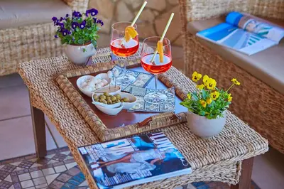 a table with a tray of food and glasses of wine at Villa Sansone in Altavilla Milicia