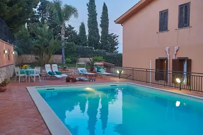 a swimming pool in front of a house at Villa Sansone in Altavilla Milicia