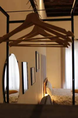 a bedroom with a bed with a wooden canopy at B&B Bandiera 77 in Palermo