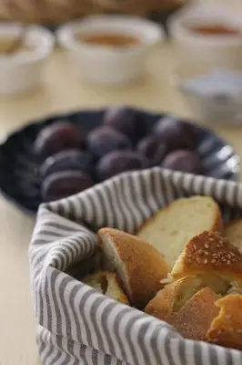 a basket of donuts and bread on a table at B&B Bandiera 77 in Palermo