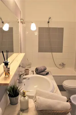 a bathroom with a sink and a tub and a toilet at B&B Bandiera 77 in Palermo