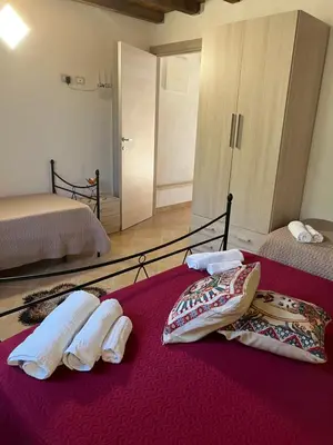 a bedroom with two beds with towels on the bed at Baglio cracchiolo da tuzzo Villa Ulivo in San Vito lo Capo