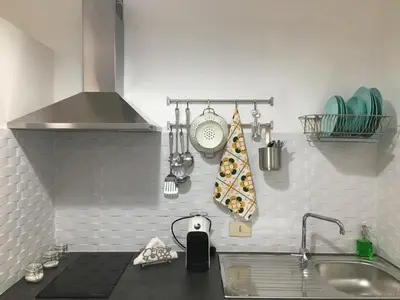 a kitchen with a counter with a sink and a stove at Casa Nicuzza in Palermo