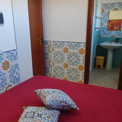 a bed with two pillows sitting on top of it at Casa Fico D'India in San Vito lo Capo