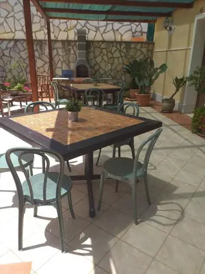 a wooden table and chairs on a patio at Casa Fico D'India in San Vito lo Capo