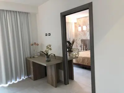 a mirror in a room with a table and a bed at Hotel Pontemare in Palermo