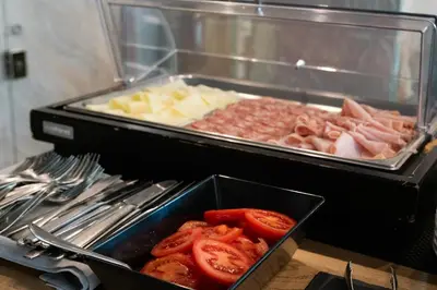 a buffet of food with tomatoes and other foods at Hotel Pontemare in Palermo