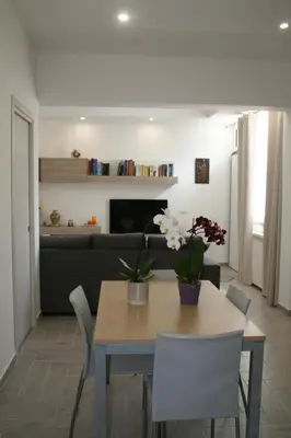 a dining table and chairs in a living room at Casa Tatiana in Palermo