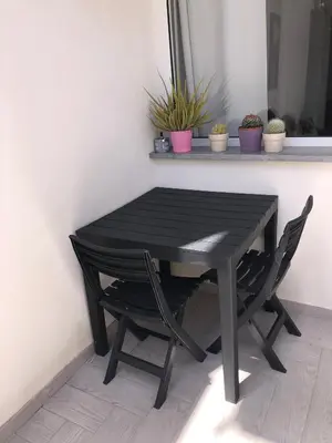 a black table and chairs in a room at Casa Tatiana in Palermo