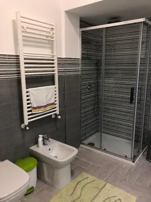a bathroom with a shower and a toilet and a sink at Casa Tatiana in Palermo