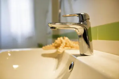 a bathroom sink with a faucet and some food at GIULIA E CHIARA LUXURY APARTMENT in Castellammare del Golfo