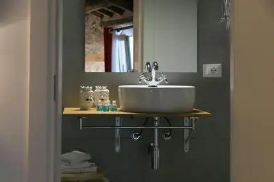 a bathroom with a sink and a mirror at Corte del Merlo in Palermo