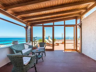 a porch with chairs and a view of the ocean at Casa con Terrazza sul Mare all'Addaura by Wonderful Italy in Palermo