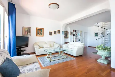 a living room with a couch and a table at Casa con Terrazza sul Mare all'Addaura by Wonderful Italy in Palermo