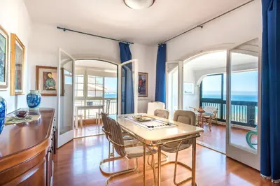 a dining room with a table and a view of the ocean at Casa con Terrazza sul Mare all'Addaura by Wonderful Italy in Palermo