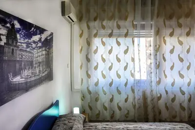 a bedroom with a window with a curtain at A Casa di Fra' in Palermo