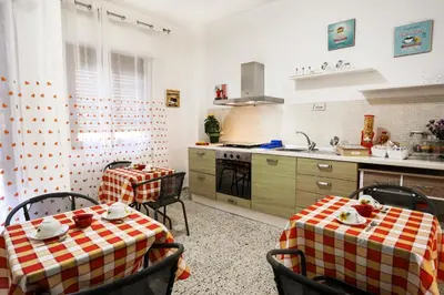 a kitchen with two tables and a sink and a stove at A Casa di Fra' in Palermo