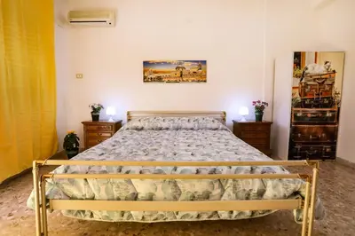 a bedroom with a bed and two night stands at A Casa di Fra' in Palermo