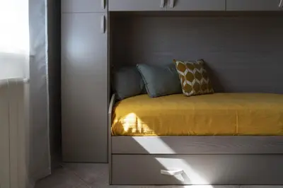 a bed with a yellow blanket and pillows on it at SICULI HORTIS SEA HOME - Villa - Jacuzzi - Air Conditioning - Free Parking - Video Surveillance & Alarm System in Altavilla Milicia