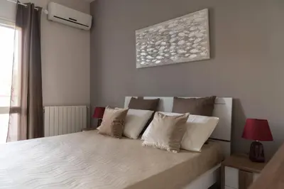 a white bedroom with a bed with white pillows at SICULI HORTIS SEA HOME - Villa - Jacuzzi - Air Conditioning - Free Parking - Video Surveillance & Alarm System in Altavilla Milicia