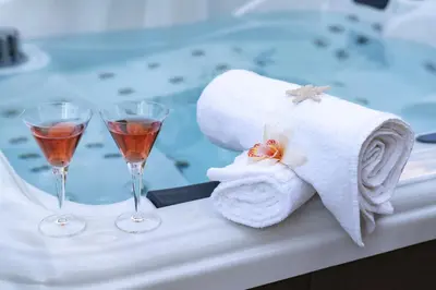 two glasses of wine and towels on a table at SICULI HORTIS SEA HOME - Villa - Jacuzzi - Air Conditioning - Free Parking - Video Surveillance & Alarm System in Altavilla Milicia