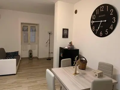 a dining room with a table and a clock on the wall at IL PANARO in Palermo
