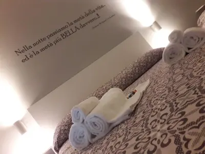 a room with a bed with towels on it at Le Stanze Dell'Emiro in Palermo
