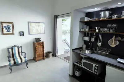 a bathroom with a mirror and a table with a stool at Naturarte Guesthouse in Terrasini