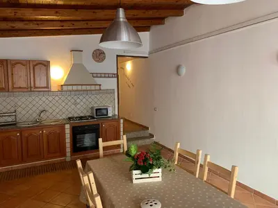 a kitchen with a table and chairs in a kitchen at Casa vacanze Villa Grace in Villagrazia