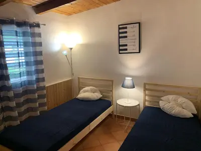 a bedroom with two beds and a lamp and a window at Casa vacanze Villa Grace in Villagrazia