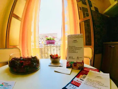 a table with a glass bowl on it with a window at Teatro Massimo Apartment- SELF CHECK-IN in Palermo