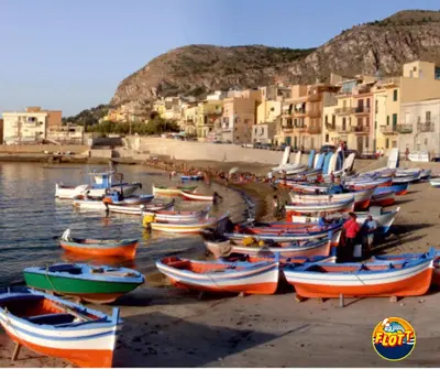 a group of boats on the shore of a beach at Aspra al delfino blu in Bagheria