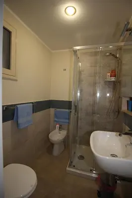 a bathroom with a shower and a toilet and a sink at Porte Maqueda in Palermo