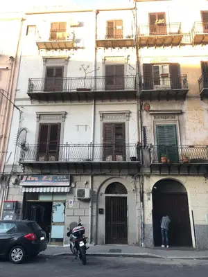 a motorcycle parked in front of a building at Porte Maqueda in Palermo