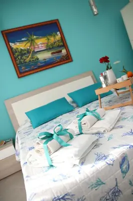 a bed with towels and bows on top of it at APPARTAMENTO L'AIRONE in Balestrate