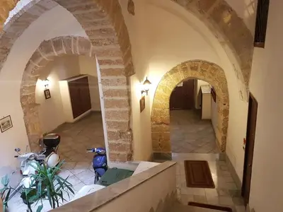 a hallway in a building with two archways at La casetta di Sara in Palermo