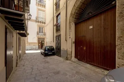 a small car parked in an alley in a building at La casetta di Sara in Palermo
