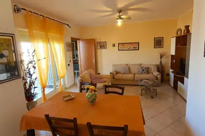 a living room with a table and a couch at Spacious apartment with sea view in Alcamo, 180 m² in Alcamo