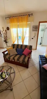 a living room with a couch and a window at Spacious apartment with sea view in Alcamo, 180 m² in Alcamo