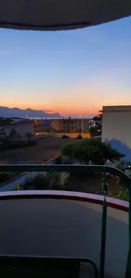 a view of a sunset from a balcony at Spacious apartment with sea view in Alcamo, 180 m² in Alcamo
