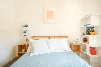 a bedroom with a bed with white shelves at Terrazza dei Colori alla Kalsa by Wonderful Italy in Palermo