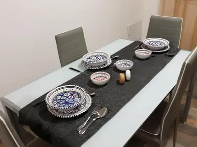 a table with plates and utensils on top of it at CASE VACANZE NONNA NICK in Castellammare del Golfo