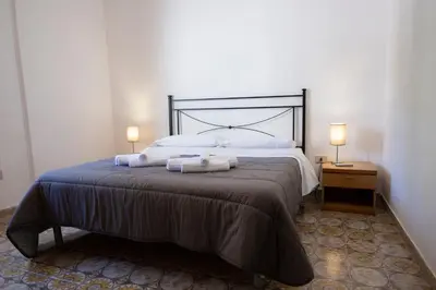 a bedroom with a large bed with two towels on it at Villa Gina con vista mozzafiato sul golfo di Macari in Macari