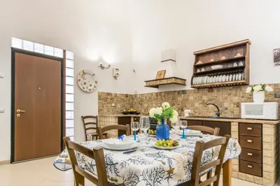a kitchen and dining room with a table and chairs at Casa marty in Mondello