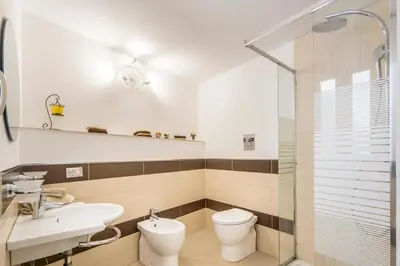 a bathroom with a toilet and a sink and a shower at Casa marty in Mondello