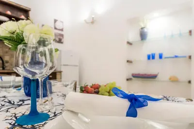 a table with a wine glass and a bowl of fruit at Casa marty in Mondello