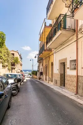 a street with cars parked on the side of the road at Casa marty in Mondello