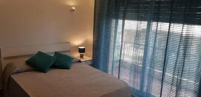 a bedroom with a bed and a large window at LA FINESTRA SUL PORTO in Palermo